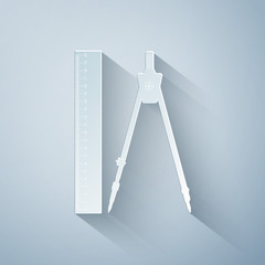 Paper cut Ruler and drawing compass icon isolated on grey background. Drawing professional instrument. Geometric equipment. Education sign. Paper art style. Vector Illustration