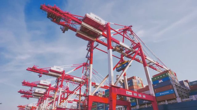 Shanghai Yangshan deepwater port is a deep water port for container ships in Hangzhou Bay south of Shanghai, China. View of the operation of the crane containers. (time-lapse)