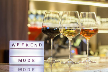 Red, rose and white wine in glasses on bar counter in the restaurant, weekend relaxation concept