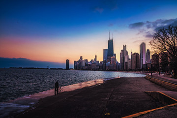 Another photographer taking a picture of the Chicago skyline at sunset. 