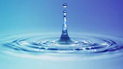 macro close up shot of real water drop surface collision with circular puddle effect in blue and...