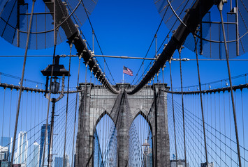 brooklyn bridge in new york on a sunny day with a blue bright sky