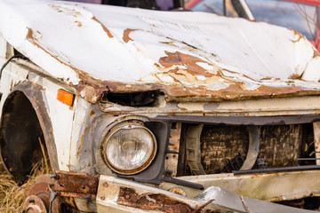 Fototapeta premium Old broken, rusting car. Rusty wrecked car. Car after the accident.