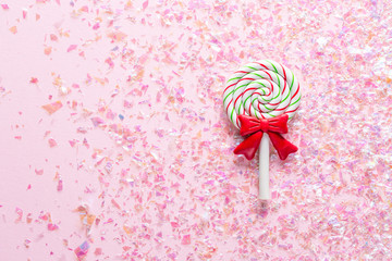 Colorful Sweet Lollipop For Children On pink Background with shiny glitter with copy space