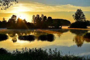 Fototapeta na wymiar Sunrise on the banks of the Daugava River. 