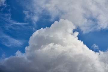 Naklejka na ściany i meble Big clouds in the blue sky in summer as background