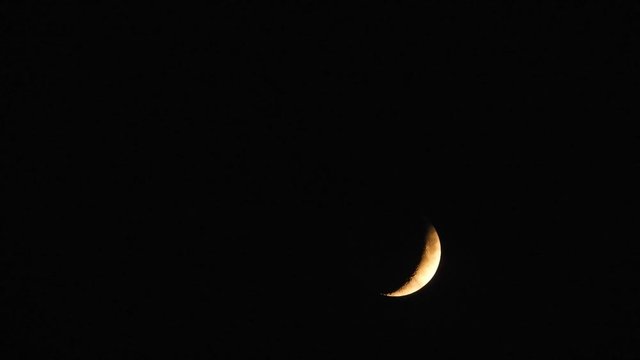 moon at night with cloud real time. 4k video full moon in the black sky.  Clouds passing by moon at night. night sky with cloudy weather
