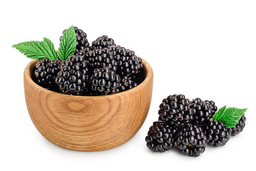 blackberry with leaf in wooden bowl isolated on a white background closeup