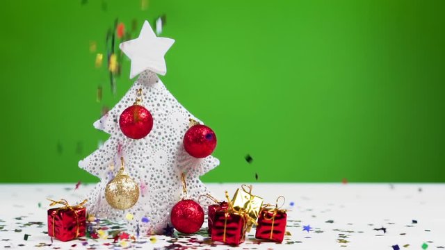 Confetti falls on a Christmas tree, slow motion. Xmas and New Year concept.