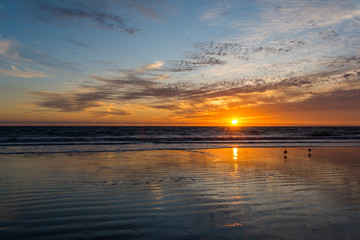Santa Monica Beach Sunset. Reflections of sky in water.