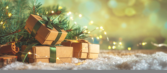 Christmas and zero waste, eco friendly packaging gifts in kraft paper on a wooden table, eco...