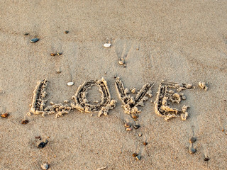 love inscription on the sand