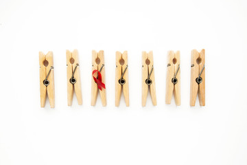wooden clothespins symbolize people with Red ribbon - World AIDS day