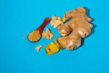 Fototapeta premium Ripe ginger root and ground on blue.