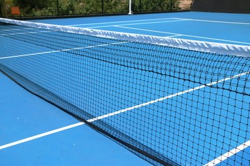 Tennis net on blue court