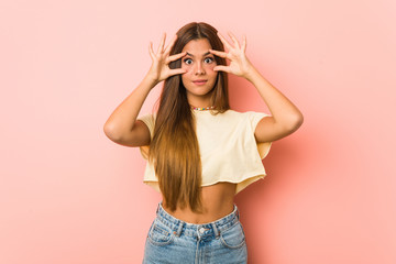 Young slim woman keeping eyes opened to find a success opportunity.