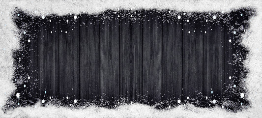 winter Background - Frame made of snow and snowflakes on wooden texture, top view with space for text