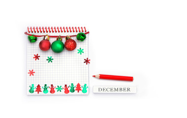 holiday new year and Christmas planning concept. December calendar.  open notebook paper, festive winter decor, stationery on white background. holiday office party. copy space