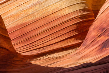Harsh light of day creates interesting shadows on colorful sandstone in orange red and pink canyon.