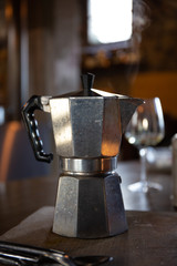 Italian tyipical vintage coffee machine close up: steam rising from the inside, fresh coffee, nice and hot.