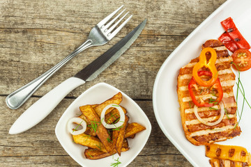 Grilled pork chop with french fries on white plate. Homemade barbecue. Healthy food.