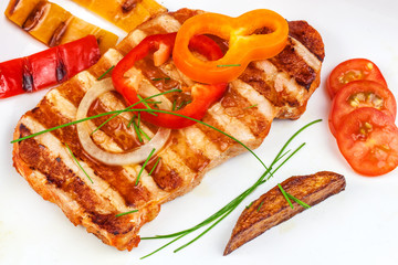 Grilled pork chop with french fries on white plate. Homemade barbecue. Healthy food.