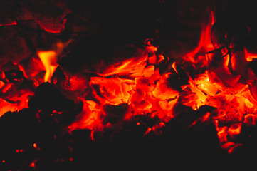 Fototapeta na wymiar Beautiful red bright coals of bonfire. Close-up.