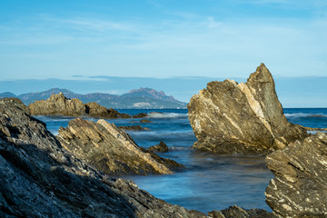 Fototapeta na wymiar long exposure of rocks at the mediterranean sea near nice