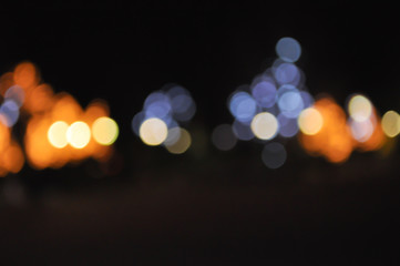 Bokeh of blue-orange lights on black background.