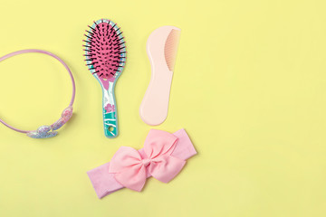 Little girl's hair accessories flat lay on bright yellow background with text space