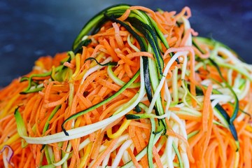 Long strands of spiral cut carrots and zucchini