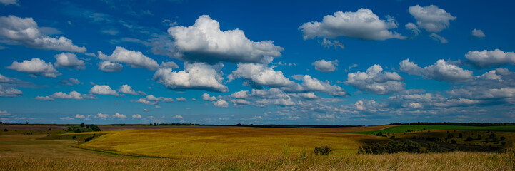 Rural landscape blue sky with clouds and meadow on a sunny day, panorama.
