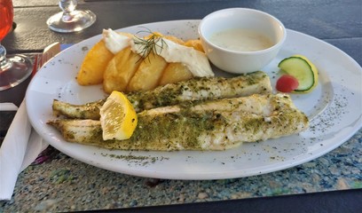 Grilled kingclip fish filet with fried potato chips.