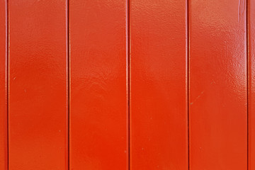 Wall of red wooden lacquered boards.