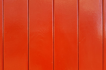 Wall of red wooden lacquered boards.