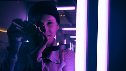 Woman using digital camera at night