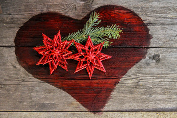Christmas composition two stars.a sprig of spruce,red heart,selective focus,Fire heart symbol