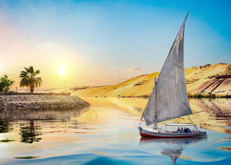 Sunset and sailboat in Aswan - obrazy, fototapety, plakaty