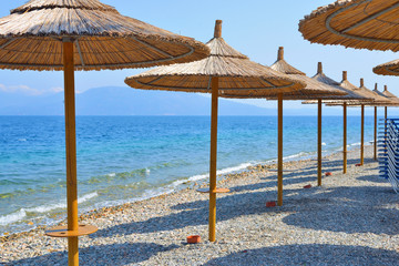 beach umbrellas made of bamboo on the banks of the sea