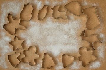 cookie cutters and cookies not a wooden background with icing sugar