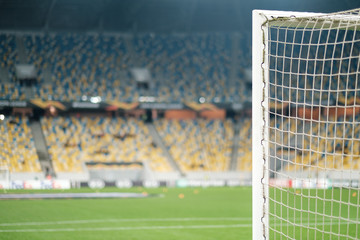 Football gate with net and view of stadium. Football game.