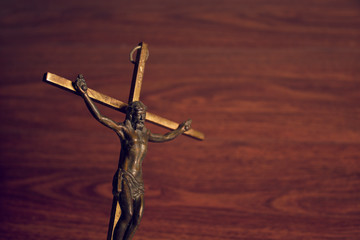 god jesus christ on gold cross with wood background, christian and peace hope religion concept