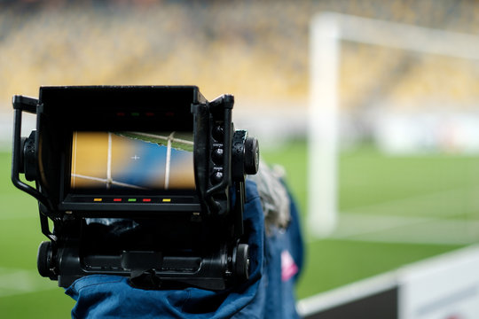 Professional camcorder in the stadium. Broadcasting a football match. Live