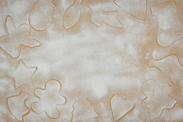 cookie cutters and cookies not a wooden background with icing sugar