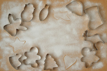 cookie cutters and cookies not a wooden background with icing sugar