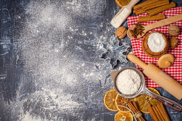 Fototapeta na wymiar Ingredients for cooking Christmas baking. Flour and spices on kitchen table top view. Bakery background.