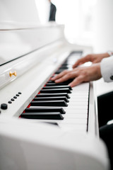 Fototapeta na wymiar a pianist in a white suit plays the piano