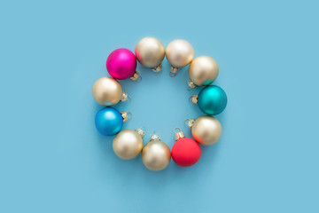 Fototapeta premium Christmas balls lie in the form of a Christmas wreath on a blue background