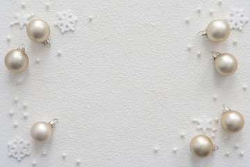Snow background with Christmas decorations balls and snowflakes with place for your text.