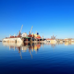 cargo ship during fixing and painting at the shipyard docks